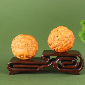 A pair of natural boxwood zodiac health balls
